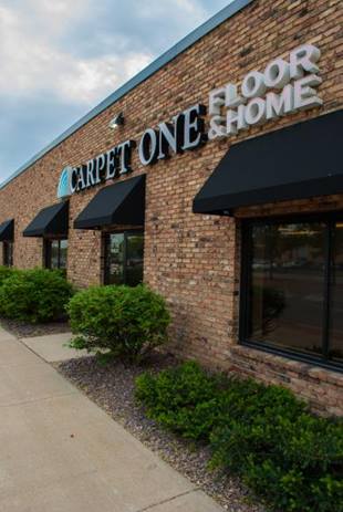 white area rug on hardwood floor with couch and art prints